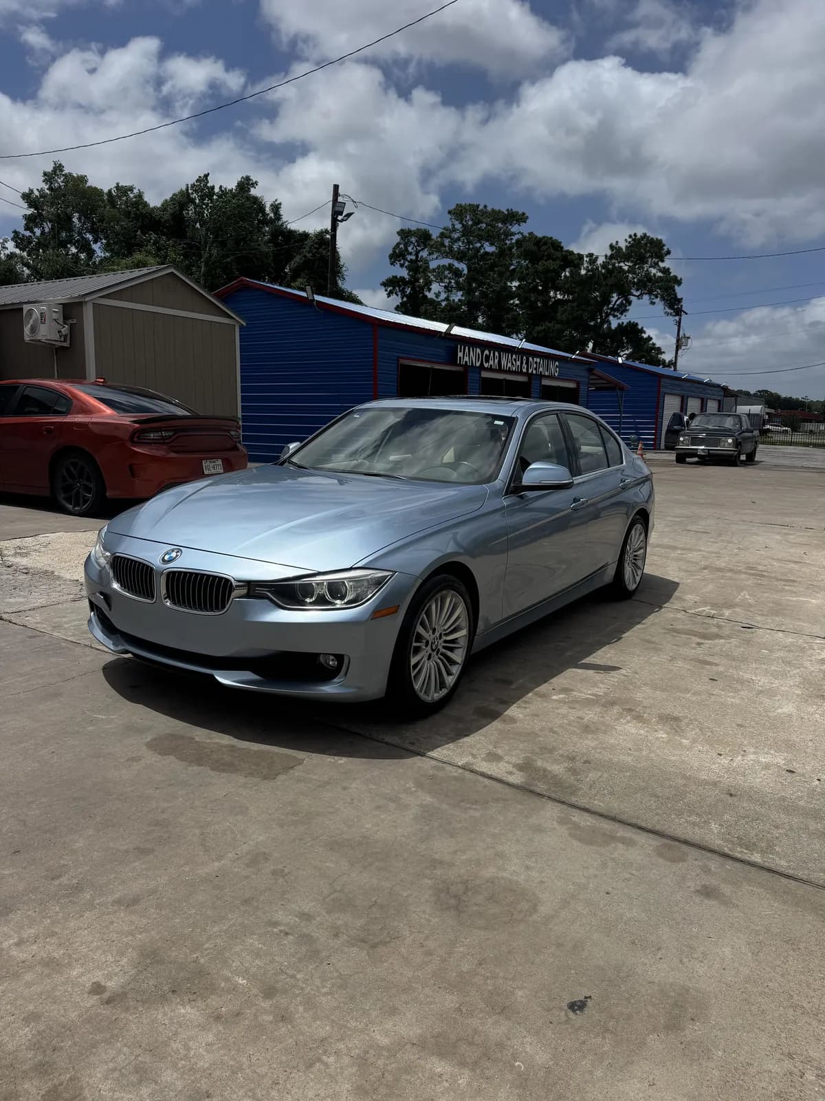 Ice-blue BMW 3 Series after a hand wash